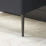 Bathroom inspiration with red walls, softly shaped red vanity and tall cabinet, elegant white sink and beautiful oval mirror with light, creating a vintage look together with the natural surroundings