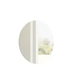 Minimalist and sleek bathroom inspiration with vanity unit, base cabinets, and tall cabinets in golden oak, large round mirror with light control, colored toilet, and countertop sink