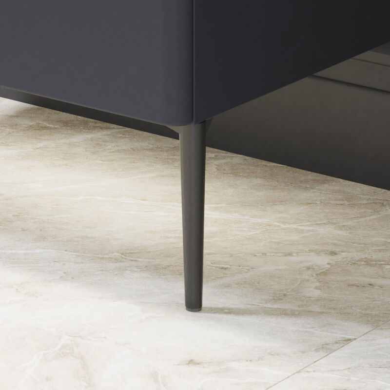 Bathroom inspiration with dark blue wall panels, romantic floral wallpaper, dark blue vanity with soft curves, and a beautiful round mirror with light, creating a vintage look