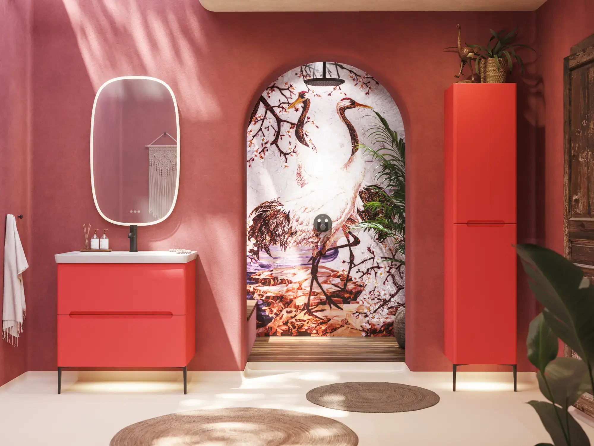 Bathroom inspiration with red walls, softly shaped red vanity and tall cabinet, elegant white sink and beautiful oval mirror with light, creating a vintage look together with the natural surroundings