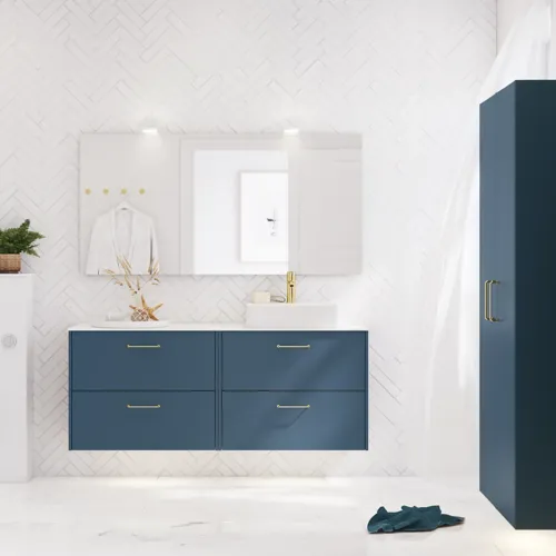 Bathroom inspiration with bathroom furniture in modern blue colour, elegant countertop basin and large square mirror with light, white herringbone tiles create a stylish and classic look