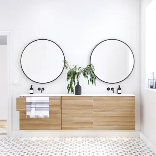 Nordic bathroom in wood finish with beautiful black framed round mirrors and plenty of storage in the furniture
