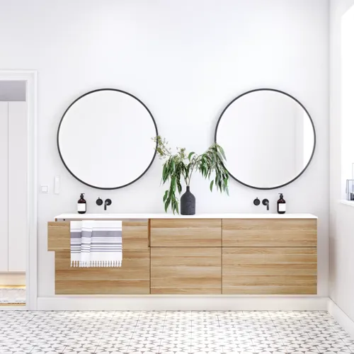 Nordic bathroom in wood finish with beautiful black framed round mirrors and plenty of storage in the furniture