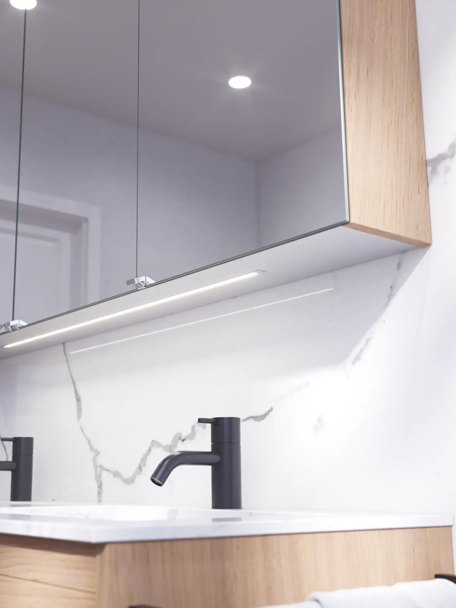 Bathroom inspiration with washbasin cabinets and wall cabinets in light oak with grooves, elegant double sink, beautiful mirror cabinet with light, herringbone floor in light wood, and white marble wall give a classic, bright, and sleek look.