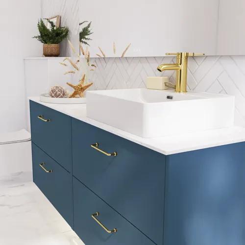 Bathroom inspiration with bathroom furniture in modern blue colour, elegant countertop basin and large square mirror with light, white herringbone tiles create a stylish and classic look
