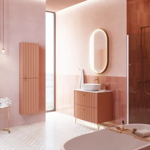 Large vintage retro bathroom inspiration with a terracotta-colored grooved vanity, elegant thin countertop with a beautiful vessel sink, stylish oval mirror with brass edge. Pink tiles and grey herringbone tiles give a romantic and feminine look