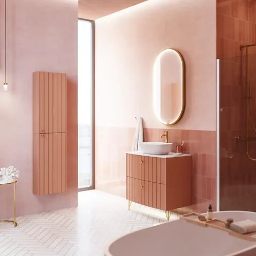 Large vintage retro bathroom inspiration with a terracotta-colored grooved vanity, elegant thin countertop with a beautiful vessel sink, stylish oval mirror with brass edge. Pink tiles and grey herringbone tiles give a romantic and feminine look