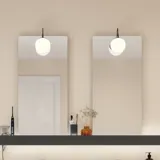 Large bathroom inspiration with brown oak furniture, black frame fronts, double sink, black shelf, rounded mirrors, black corner shower with folding doors, white tiles, and beige walls for a modern look