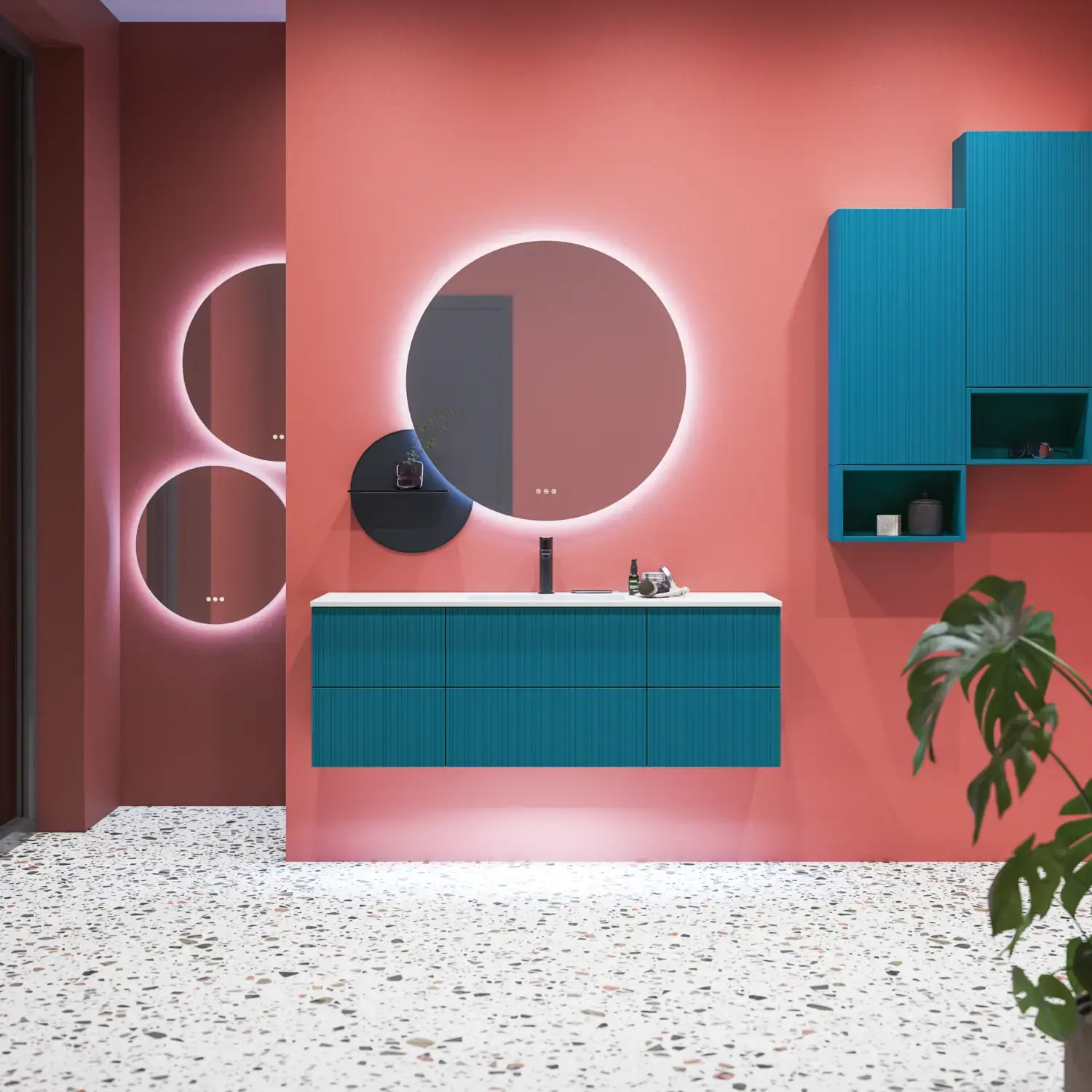 Large bathroom inspiration with blue special color grooved furniture, thin elegant sink, and beautiful round mirrors, red walls, and terrazzo floor create a strong contrast to the furniture, giving a stylish and urban look.