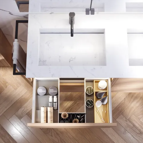 Bathroom inspiration with washbasin cabinets and wall cabinets in light oak with grooves, elegant double sink, beautiful mirror cabinet with light, herringbone floor in light wood, and white marble wall give a classic, bright, and sleek look.