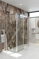 Bathroom inspiration with luxurious shower cubicle with sliding door, white bathroom furniture and a raw-look wall that gives the bathroom a raw and urban feel