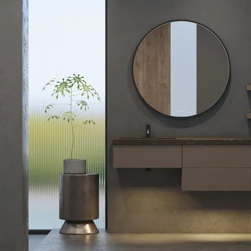 Stylish and spacious bathroom inspiration with a large round mirror with a black frame, dark stone sink, colored toilet, upper cabinet, and open shelf in a sophisticated and muted design