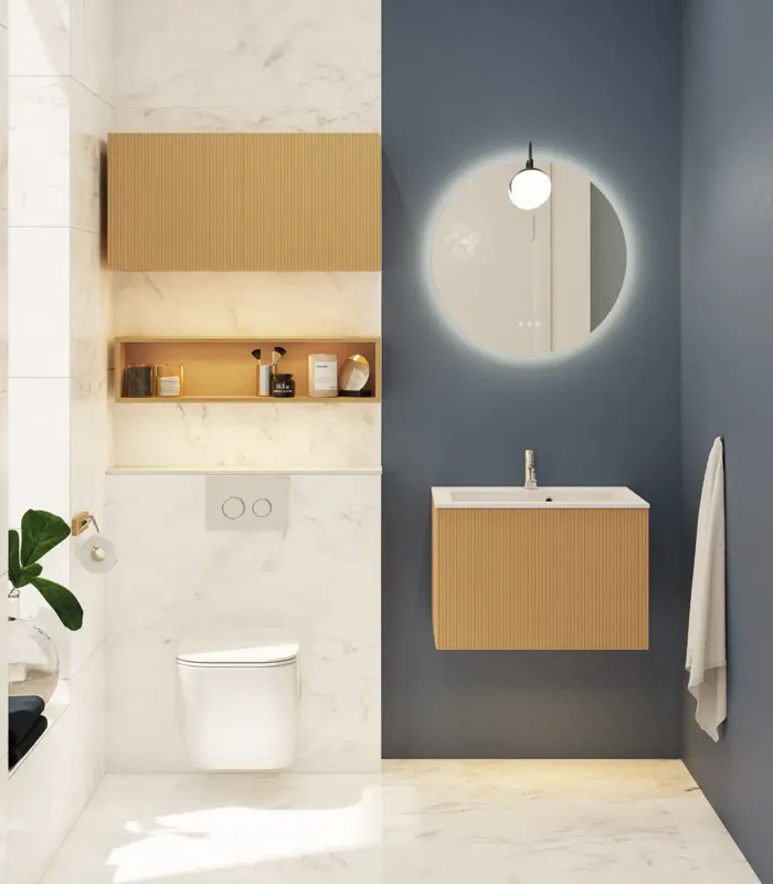 Small, stylish bathroom with dark blue walls, soft yellow bathroom furniture with grooves, and an elegant round mirror with lamp