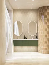 Large and luxurious bathroom with lovely oval mirrors and beautiful tiles in natural colours