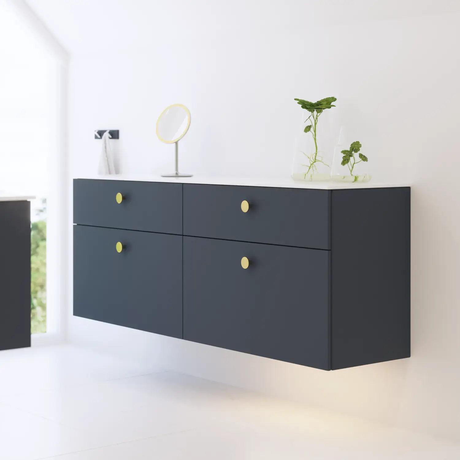 Elegant and modern bathroom inspiration with slanted ceiling, wall-mounted blue vanity unit and base cabinets, round sink with brass faucet, illuminated mirror, and natural light