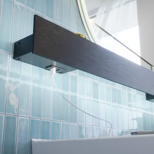 Bathroom inspiration with elongated blue tiles, natural oak bathroom furniture with black details, creating a harmonious and sophisticated look