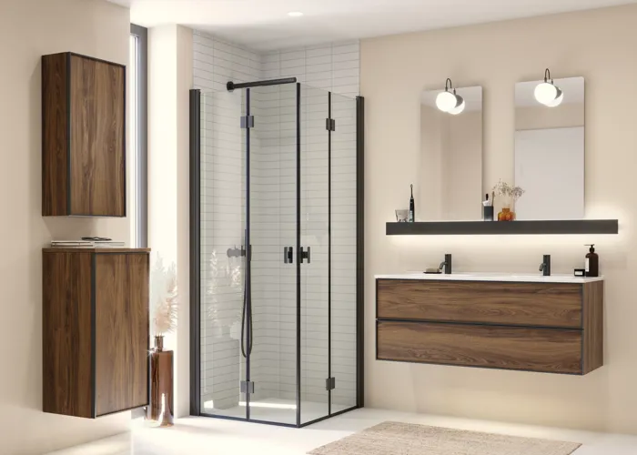 Large bathroom inspiration with brown oak furniture, black frame fronts, double sink, black shelf, rounded mirrors, black corner shower with folding doors, white tiles, and beige walls for a modern look
