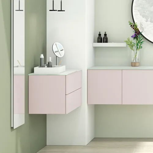 Large and bright bathroom in a minimalist style with soft pastel colours and elegant green hues, stylish round mirror and modern décor
