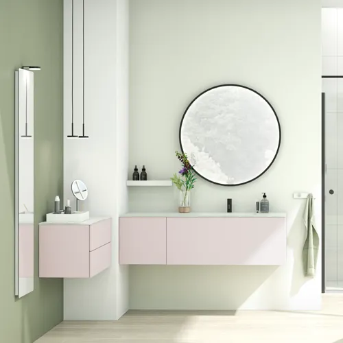 Large and bright bathroom in a minimalist style with soft pastel colours and elegant green hues, stylish round mirror and modern décor