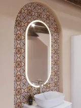 Large bathroom inspiration with white ribbed furniture, elegant countertops and countertop basins, oval mirrors with lights, exposed beams and patterned tiles create a vintage and stylish look