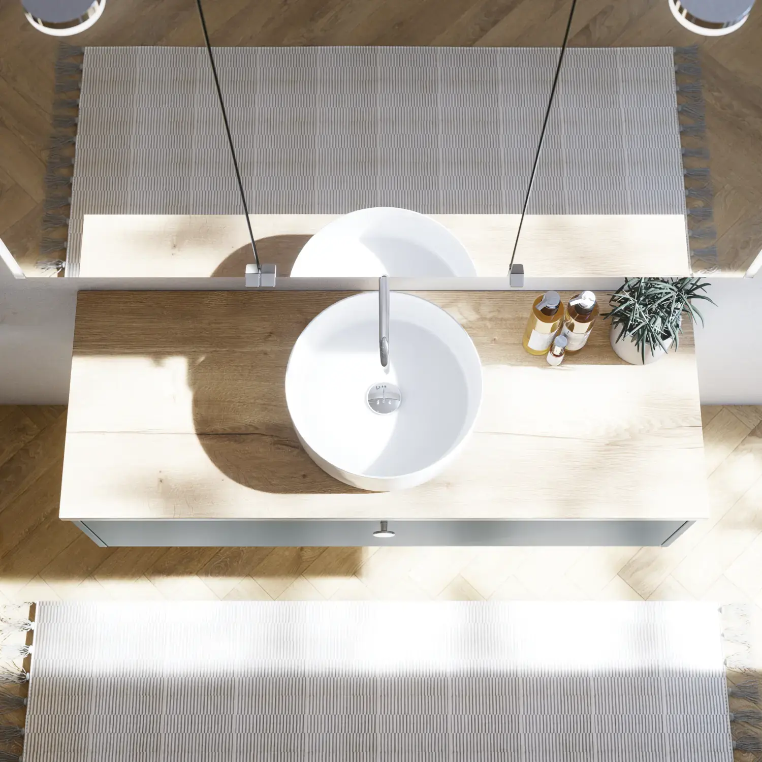 Large bathroom inspiration in Nordic style with bathroom furniture in light blue colour and wooden countertop with elegant countertop basin, herringbone wooden floor creating a bright and classic style