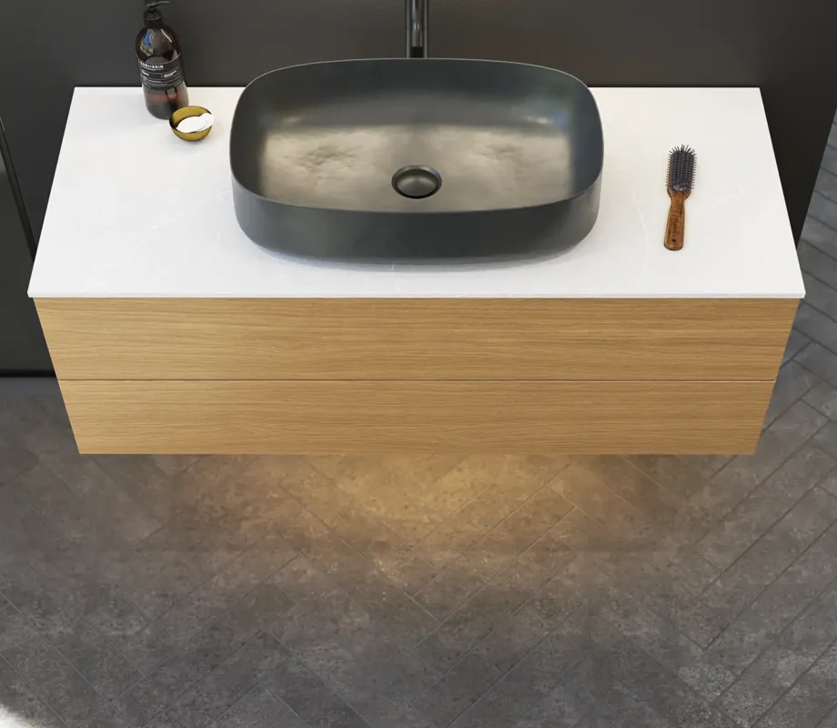 Minimalist and sleek bathroom inspiration with vanity unit, base cabinets, and tall cabinets in golden oak, large round mirror with light control, colored toilet, and countertop sink