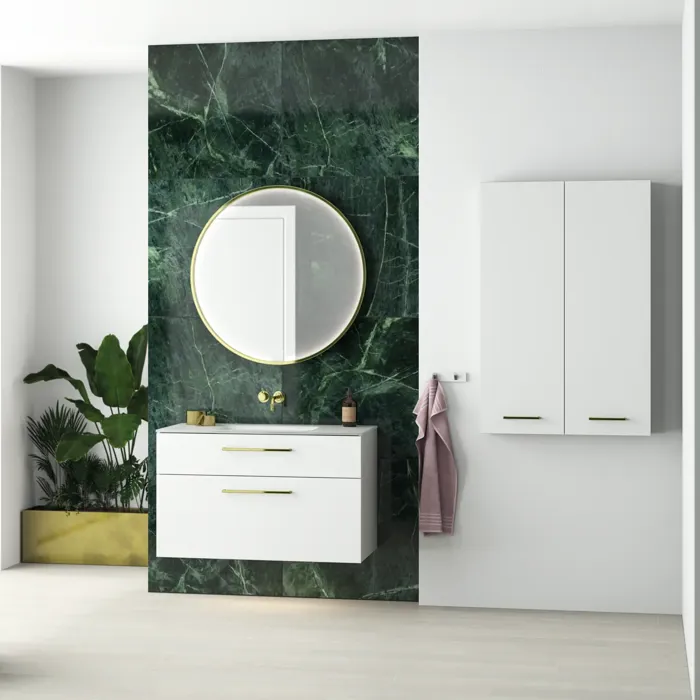 Stylish and luxurious bathroom with a dark green marble wall, large elegant round mirror, and modern white bathroom furniture.