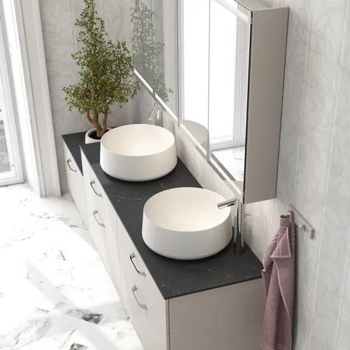 Romantic bathroom inspiration with mirror cabinet offering practical and graceful storage solutions, double countertop sinks on a stone countertop.