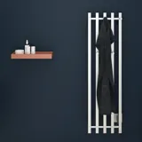 Stylish bathroom with dark blue walls, electric towel warmer, and rust-colored wooden shelf.