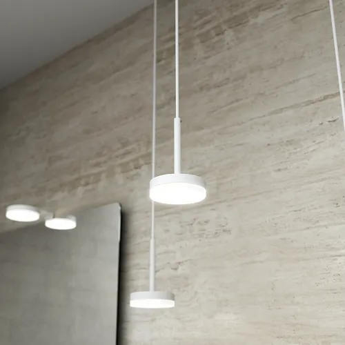 Sleek bathroom with elegant white ceiling lamps and matching lights above a stylish mirror with rounded corners.