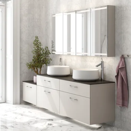 Romantic bathroom inspiration with mirror cabinet offering practical and graceful storage solutions, double countertop sinks on a stone countertop.