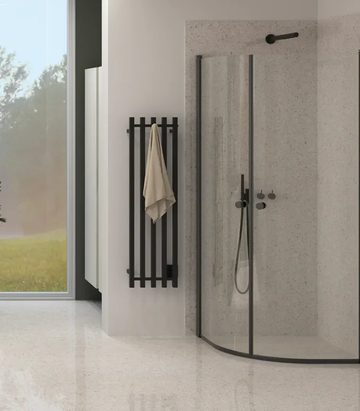 Large bathroom inspiration with custom-coloured vanity units and integrated handles, round mirrors for a symmetrical look, rounded shower cabin doors, electric towel warmer, and stylish green hues.