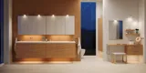 Modern bathroom in Nordic style with light wood, elegant lighting, mirror cabinet wall, and stylish decor, creating a warm and inviting atmosphere.