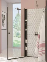 Large bathroom inspiration with white bathroom furniture, square mirror, and shower screen with swing doors with clear glass and profiles in matt black, as well as an elegant electric heated towel rail.