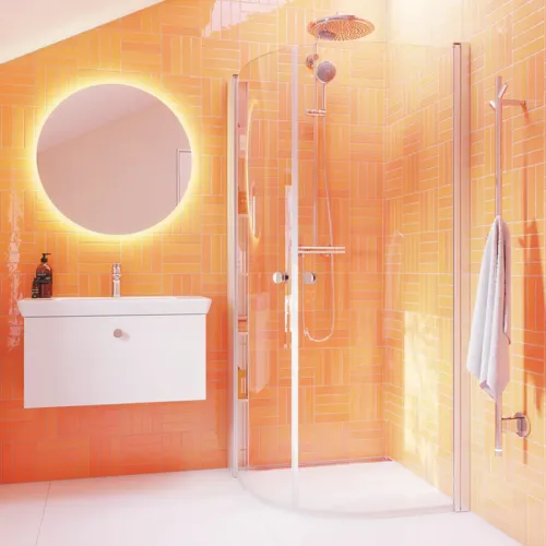 Bathroom inspiration with white wash cabinet with round mirror, rounded shower doors in clear glass and profiles in satin, with practical and stylish electric towel dryer and bathroom shelf.