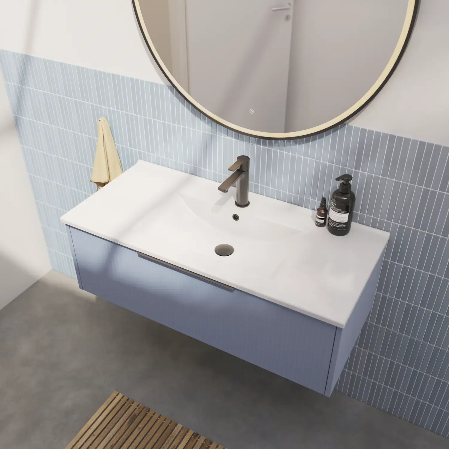 Bathroom inspiration with elongated light blue tiles and concrete floor, elegant light blue vanity with beautiful narrow stripes, sleek and thin sink, and a minimalist round mirror with a black edge and light, adding a touch of elegance to your bathroom.
