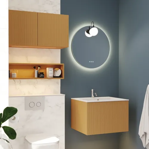 Small, stylish bathroom with dark blue walls, soft yellow bathroom furniture with grooves, and an elegant round mirror with lamp.