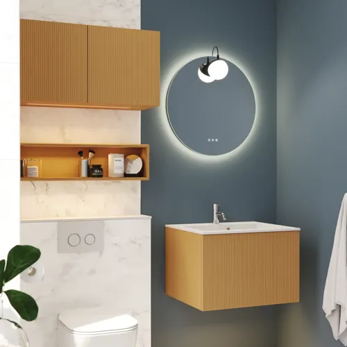 Small, stylish bathroom with dark blue walls, soft yellow bathroom furniture with grooves, and an elegant round mirror with lamp.
