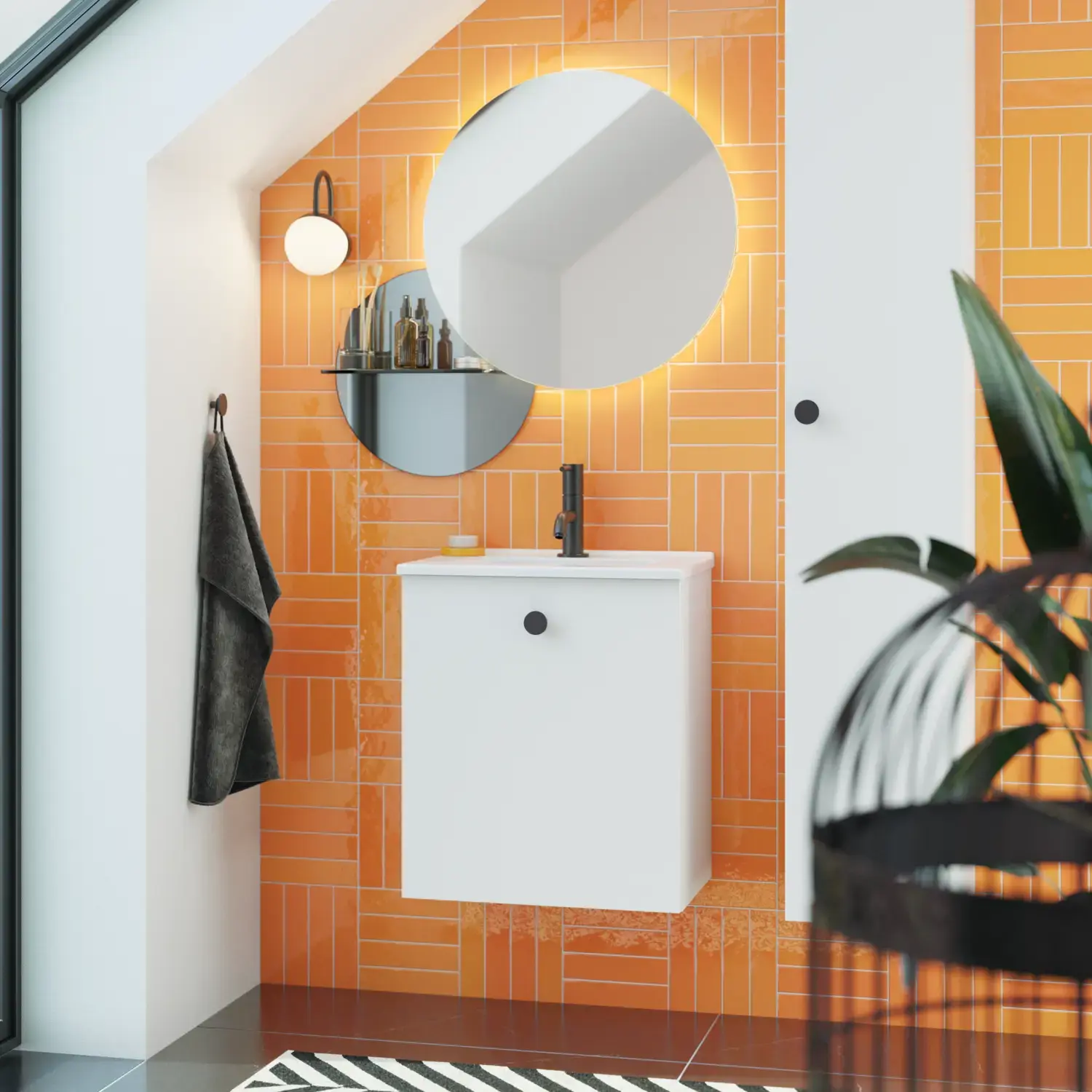 Bathroom with sloping ceiling inspiration with small white vanity unit and tall cabinet with round black handles, as well as beautiful round mirror, orange tiles give a fresh and modern look.