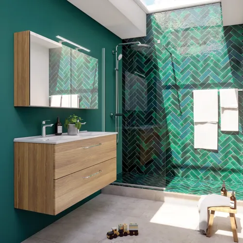 Large bathroom inspiration with a vanity unit in Warm Oak, elegant double sink, beautiful mirror cabinet and shower screen, green herringbone tiles for a sophisticated look.