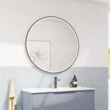 Bathroom inspiration with elongated light blue tiles and concrete floor, elegant light blue vanity unit with beautiful narrow stripes, sleek and thin sink, double tall cabinet with narrow stripes, and a minimalist round mirror with a black edge and light.