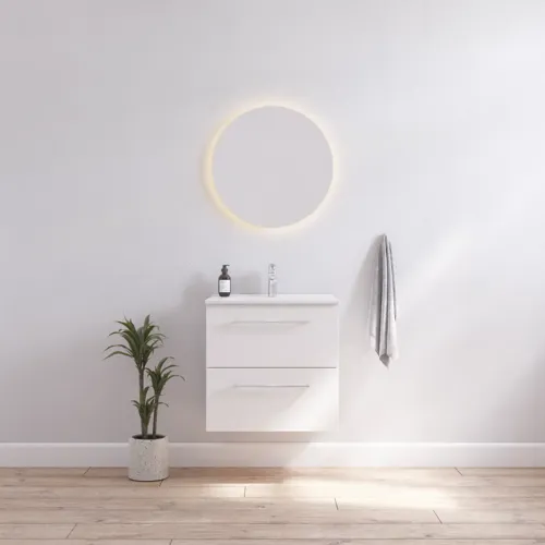 Bathroom inspiration with narrow white vanity unit with white handles and elegant washbasin with beautiful round mirror with light, white walls and wooden floor for a bright and minimalist look.