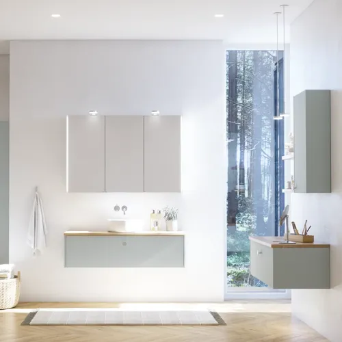 Large bathroom inspiration in Nordic style with bathroom furniture in light blue colour and wooden countertop with elegant countertop basin, herringbone wooden floor creating a bright and classic style