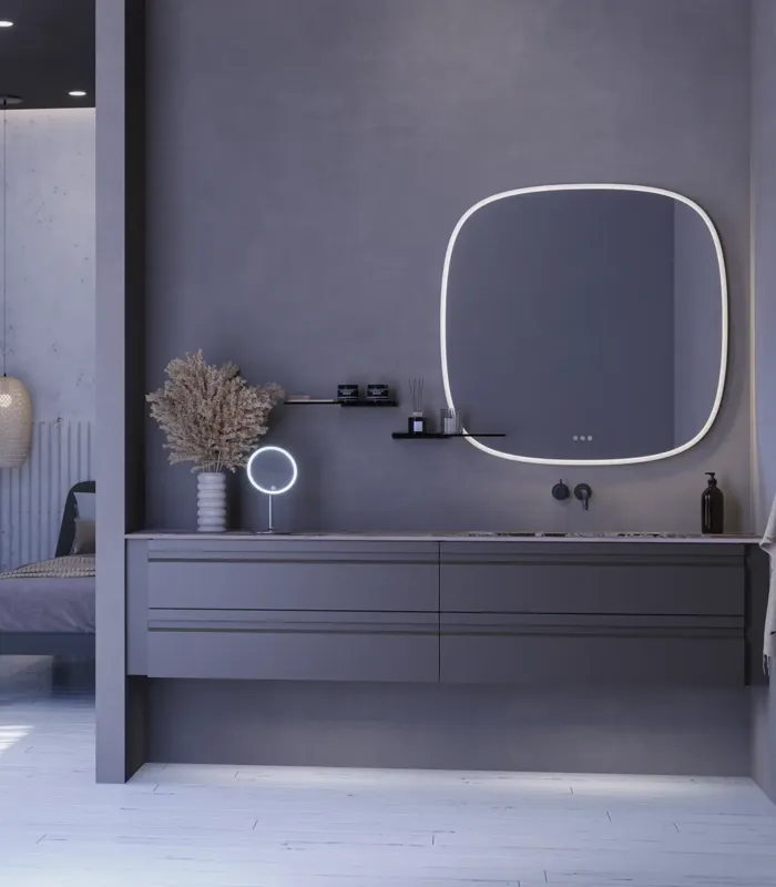 Large bathroom inspiration with grey vanity unit with integrated handle, stylish side-mounted sink, square mirror with rounded corners, concrete-look walls and raw materials for an urban look