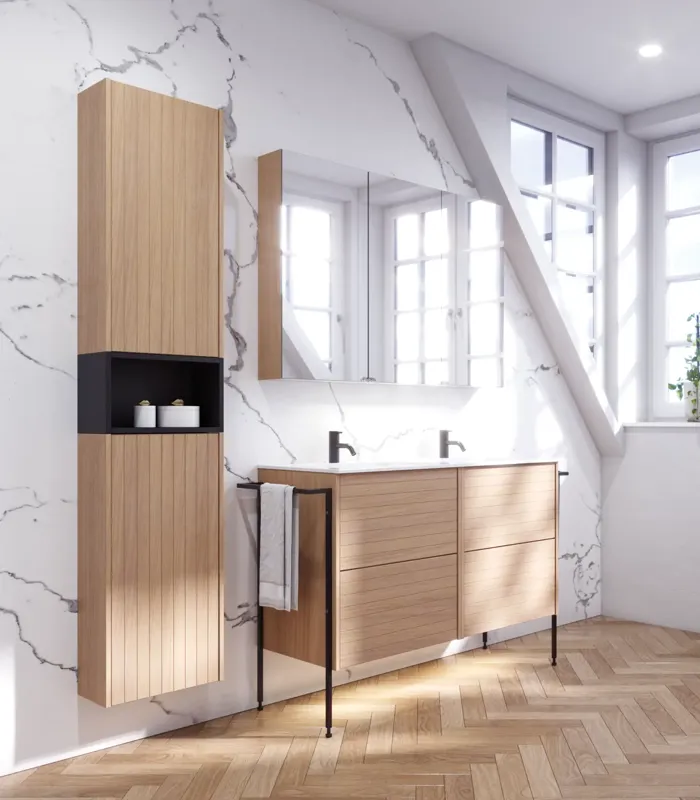 Bathroom inspiration with washbasin cabinets and wall cabinets in light oak with grooves, elegant double sink, beautiful mirror cabinet with light, herringbone floor in light wood, and white marble wall give a classic, bright, and sleek look.