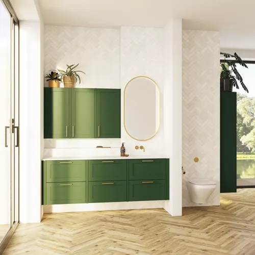 Large bathroom in green colors with vanity unit, brass framed oval mirror and beautiful framed doors
