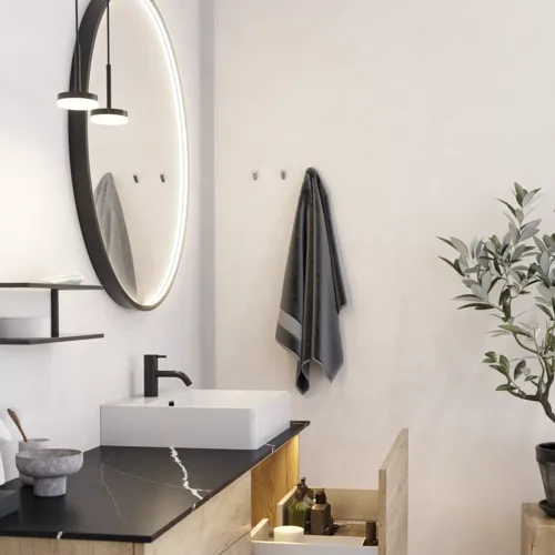 Large urban bathroom inspiration with natural oak furniture, stone countertop with square basin, round mirror with black frame, natural colors, and terracotta floor for an industrial and modern look